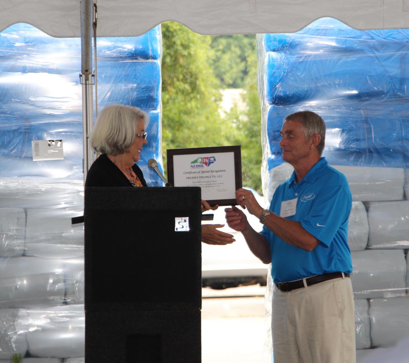 NCDOL Commissioner of Labor, Cherie Berry, presents the seventh consecutive Certificate of Safety Achievement Award to VP of Mulch Manufacturing for Profile Products, Gary Bowers.