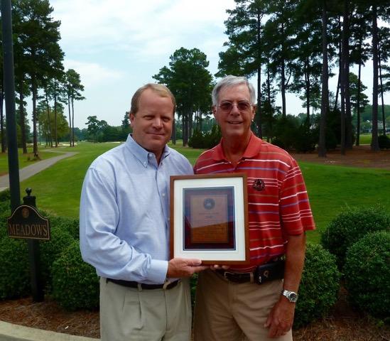 John Maeder (left) is presented with a commemorative plaque on behalf of the ASGCA.