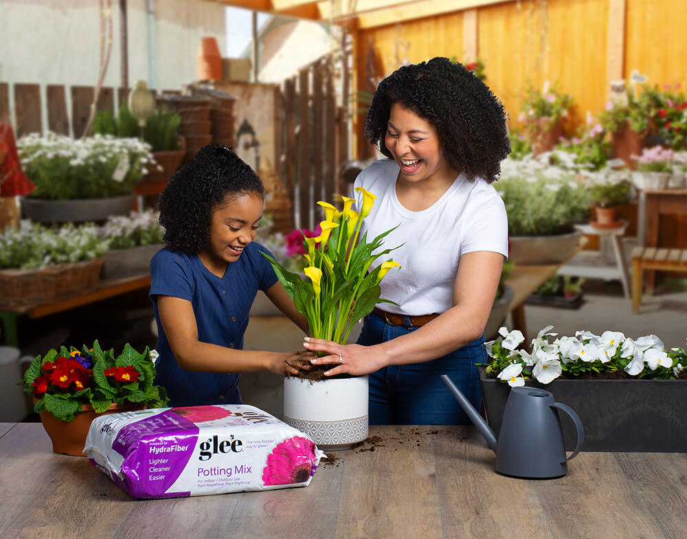 "mother daughter planting with glee grows potting mix"